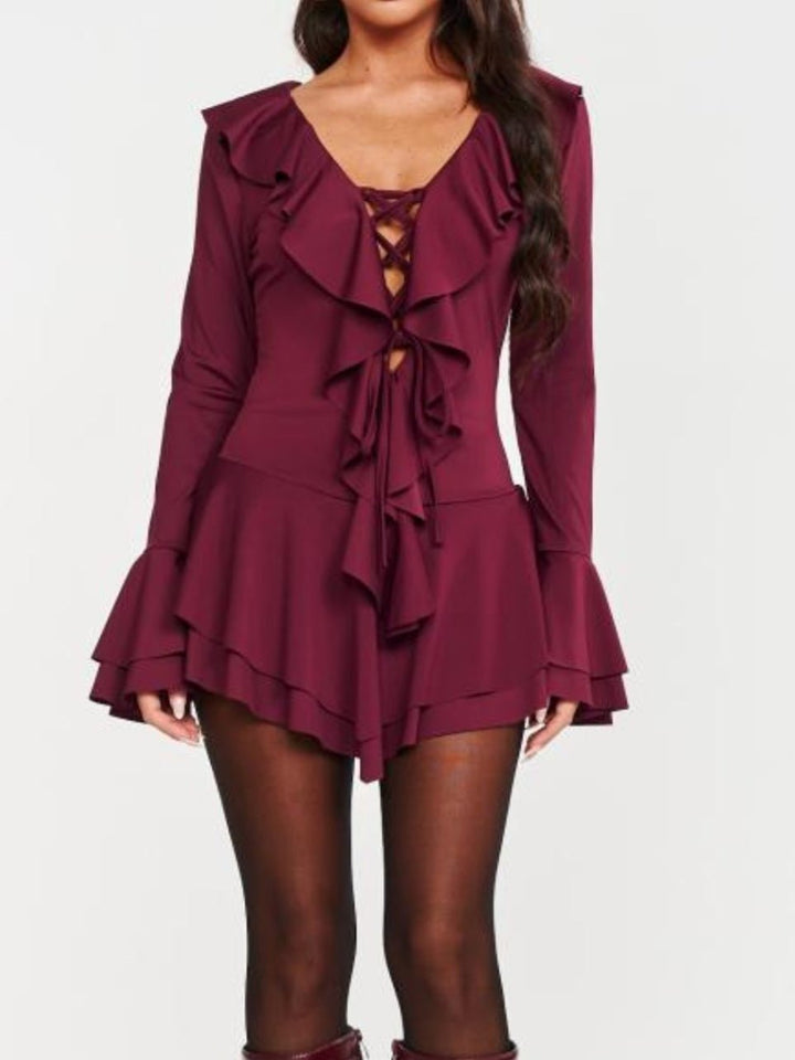 Abito in tessuto elasticizzato scollo a v con lacci manica lunga gonna con volant a balza Bordo Level Stores